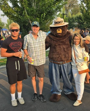 Raven with family and Smokey Bear at a local community event